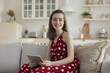 Happy pretty young adult girl in trendy summer dress using tablet at home, posing for portrait, looking at camera, smiling, promoting domestic internet communication, wireless technology