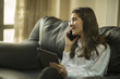 © ayse - businesswoman talking by phone in office, working with tablet