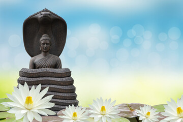 Wall Mural - Buddha statue and lotus flowers on bokeh background.