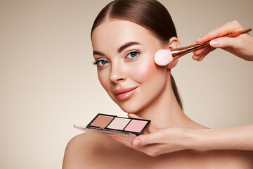 Wall Mural - makeup artist applies eye shadow. beautiful woman face. perfect makeup. make-up detail. beauty girl 