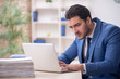 © Elnur - Young male employee and too much work in the office