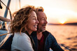 © tilialucida - Happy senior couple in love enjoying a romantic sunset on yacht in the sea, Generative AI