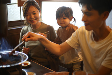 焼肉店で食事をする親子