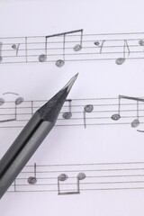 Wall Mural - Sheet with musical notes and pencil, top view