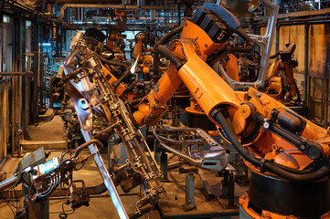 Contemporary robotic welding machines in plant workshop