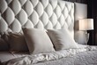 White leather headboard with a quilted white surface, soft white quilted pillow, and coverlet. Clean pillow, comfort, close up of a bed component. Background of quilted headboard and Generative AI
