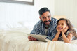 Bed, digital tablet and girl laughing with father, relax and sharing comic or joke in their home together. Happy, comedy and parent and with girl in bedroom online for funny meme or subscription