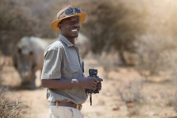 portrait, safari and wildlife with a man ranger outdoor in a game park for nature conservation. anim