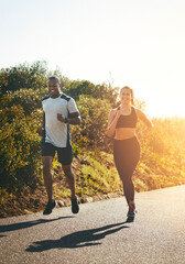 Poster - Freedom, running and happy with couple in road for workout, cardio performance and summer. Marathon, exercise and teamwork with black man and woman runner in nature for sports, training and race