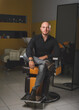 © sandor - Portrait of a barber sitting in a barber's chair in his workplace.