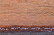 Full frame texture background of an antique exterior red brick wall with salt deposits from moisture and efflorescence