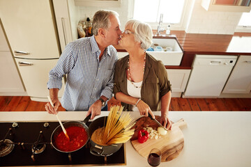 Wall Mural - Top view, kiss or old couple kitchen cooking with healthy food for lunch or dinner together at home. Love, help or senior woman bonding or kissing mature husband in meal preparation in retirement