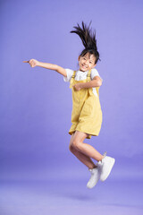 cute asian baby girl posing on purple background