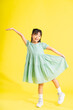 happy smiling asian girl on yellow background