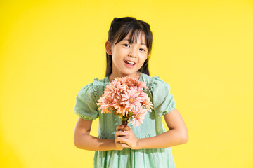 Wall Mural - happy smiling asian girl on yellow background