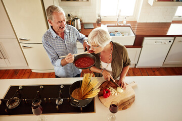 Poster - Top view, tasting or old couple kitchen cooking with healthy food for lunch or dinner together at home. Love, taste or senior woman helping or eating with mature man in meal preparation in retirement