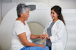 © Laflor/peopleimages.com - Doctor, ct scan and woman holding hands of patient in hospital before scanning in machine. Mri, comfort and happy medical professional with senior female person before radiology test for healthcare.