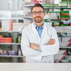 Poster - Success, crossed arms and portrait of pharmacist in pharmacy clinic standing with confidence. Healthcare, medical and mature male chemist by the counter of pharmaceutical medication store dispensary.