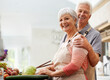 © Anne/peopleimages.com - Cooking, nutrition and portrait of old couple in kitchen for salad, love and health. Happy, smile and retirement with senior man and woman cutting vegetables at home for food, dinner or recipe mockup