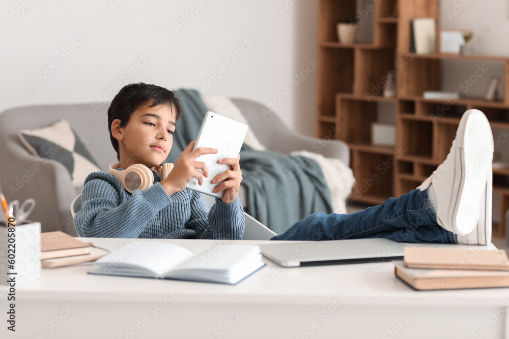 Little boy using tablet computer at home