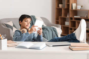 Poster - Little boy using tablet computer at home