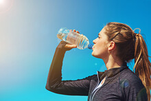Woman Drinking Water, Health And Fitness With Blue Sky, Athlete Outdoor With Hydration And Mockup Space. Sports, Exercise And Female Person With H2o Drink In Bottle, Workout And Break From Training