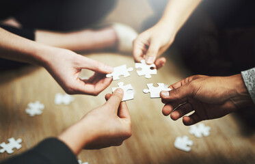 Aufkleber - Hands, business people and puzzle in circle, closeup and teamwork for problem solving, solution and game. Group, together and helping hand for jigsaw, solidarity and team building on office floor