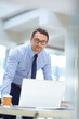 © GR/peopleimages.com - Portrait, laptop and mindset with a business man at work in his office for research or solution. Computer, mission and management of a male employee working on a tech report or planning for success