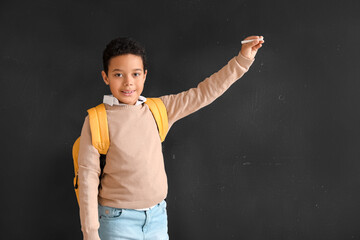 Sticker - Little African-American boy with chalk piece drawing on blackboard. Children's Day celebration