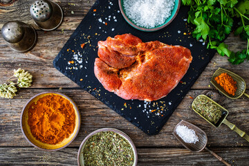 Wall Mural - Fresh raw slices of pork neck on cutting board on wooden table
