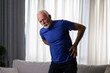 © Space_Cat - Elderly man holding hand on his lower back, suffering from osteoarthritis pain at home