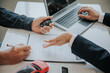 © Witoon - The young businessman made a lease for a new car in the office of a car dealer and received the keys after the contract was completed. The concept of a car purchase contract