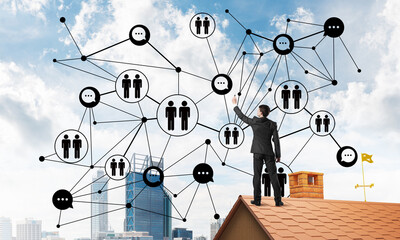 businessman on house roof presenting networking and connection concept. mixed media