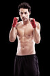 © Lionel H/peopleimages.com - Boxing, man and portrait in studio for fitness exercise in competition martial arts training. Champion, fist and model for professional workout with focus on health and wellness goal at sport club.