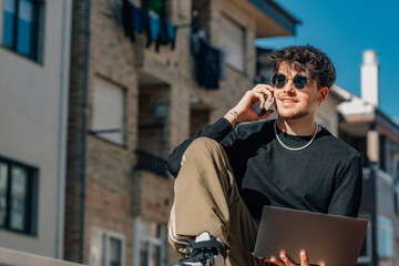 Canvas Print - young man with mobile phone and laptop outdoors