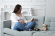 © Volodymyr - Pregnant woman sitting hold ultrasound photo of belly strokes tummy fetus abdomen enjoying pregnancy. Future family, baby infant expecting child inside