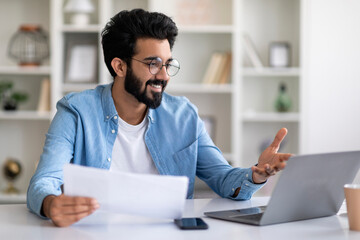 Wall Mural - Young Indian Freelancer Man Making Video Call With Laptop At Home