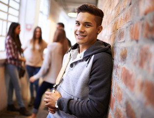 Aufkleber - Education, happy and portrait of man in college hallway for studying, learning and scholarship. Future, smile and knowledge with student leaning on brick wall for university, academy and campus