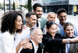 © carlesiturbe - Multiracial group of successful business people taking a selfie outside. Diverse office colleagues taking a picture together smiling and bonding in the street.
