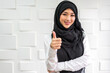 © Art_Photo - Beautiful happy confident asian muslim businesswoman smart looking at camara on office workplace desk.Young muslim creative coworkers business people working and planning