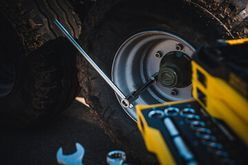 Wall Mural - Mechanical tools box. Worker using different repair tools for repairing and service. Tool set near the auto. Closeup. Automobile servicing and repair concept.