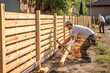 © MVProductions - Builders constructing a fence. Fence builders. Generative AI