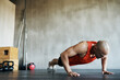 © Nicola Katie/peopleimages.com - Workout, muscular and man doing gym studio push up for exercise, health performance and sports training for muscle building. Bodybuilding routine, determination or strong person doing floor pushup