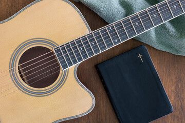 Wall Mural - Guitar and bible book on wooden background, top view.