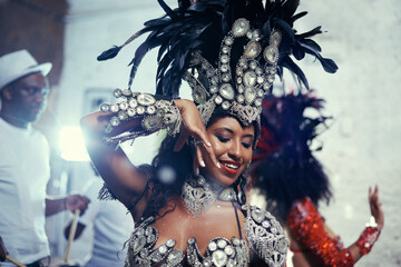 Festival, carnival and dancer woman in samba with smile, music and party celebration in Brazil. Mardi gras, dancing or culture event costume with a young female person with happiness from performance