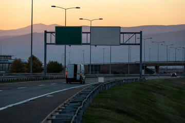 Wall Mural - White delivery van on the highway. White modern delivery small shipment cargo courier van moving fast on motorway road to city urban suburb. The business distribution and logistics express service.