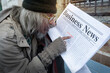 © chomplearn_2001 - Older homeless people looking for jobs posted in newspapers, unemployment and homeless people concept