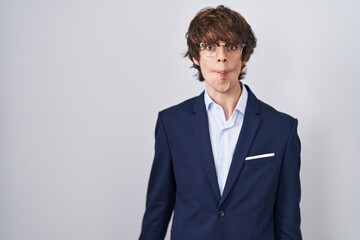 Canvas Print - Hispanic business young man wearing glasses making fish face with lips, crazy and comical gesture. funny expression.