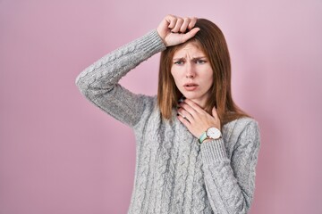 Canvas Print - Beautiful woman standing over pink background touching forehead for illness and fever, flu and cold, virus sick