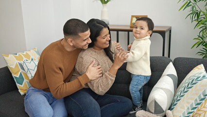 Poster - Couple and son hugging each other sitting on sofa at home